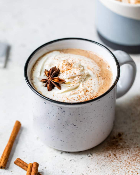 Chai Spice Turkey Tail Coffee in a mug surrounded by spices. A comforting blend of antioxidant-rich mushroom and chai flavors.